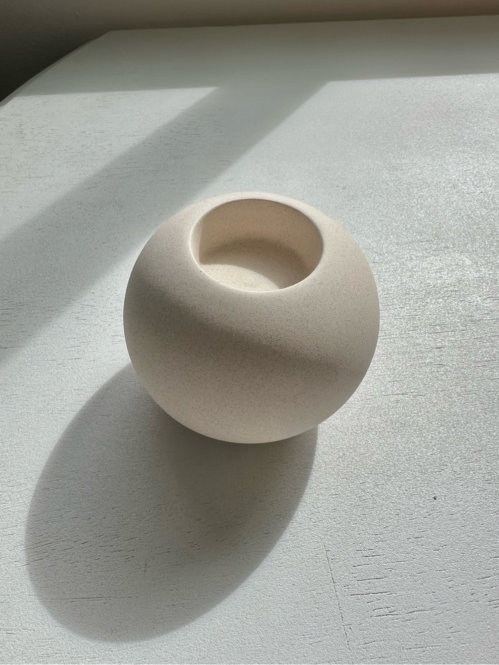 Minimalist textured matte ceramic round tea light candle holder in neutral beige